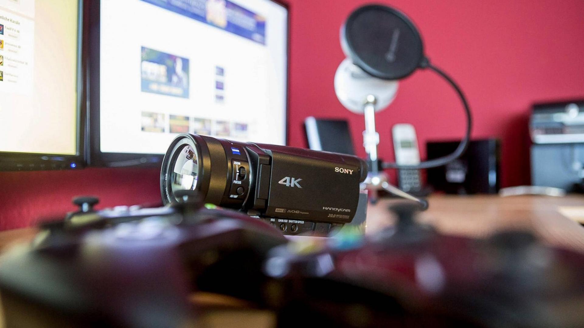 Kamera, Kopfhörer, Bildschirm: Die Ausrüstung eines Youtube-Kanals von Konsolen-Spielern. Kamera, Kopfhörer, Bildschirm: Die Ausrüstung eines Youtube-Kanals von Konsolen-Spielern.