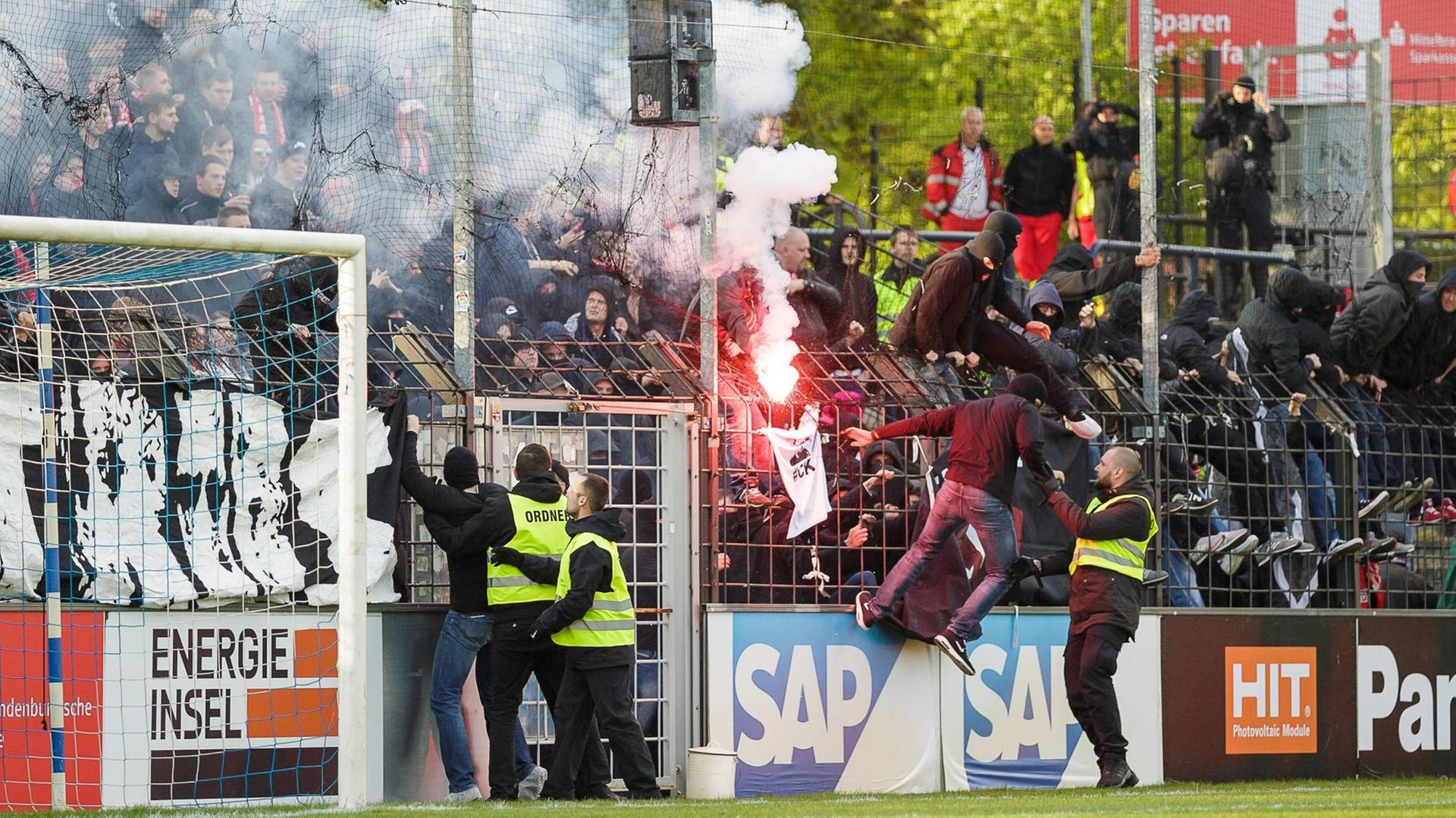 Cottbusser Fans zünden Pyrotechnik und stürmen den Platz. Cottbusser Fans zünden Pyrotechnik und stürmen den Platz.