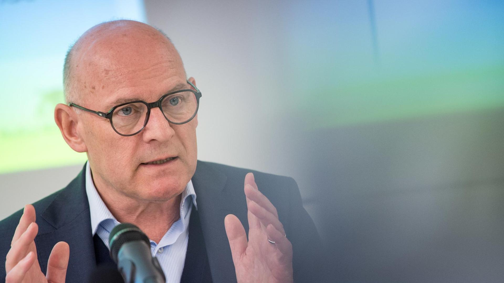 Winfried Hermann (Bündnis 90/Die Grünen), Verkehrsminister von Baden-Württemberg, spricht bei einer Pressekonferenz in ein Mikrofon und gestikuliert mit beiden Händen. Winfried Hermann (Bündnis 90/Die Grünen), Verkehrsminister von Baden-Württemberg, spricht bei einer Pressekonferenz in ein Mikrofon und gestikuliert mit beiden Händen.