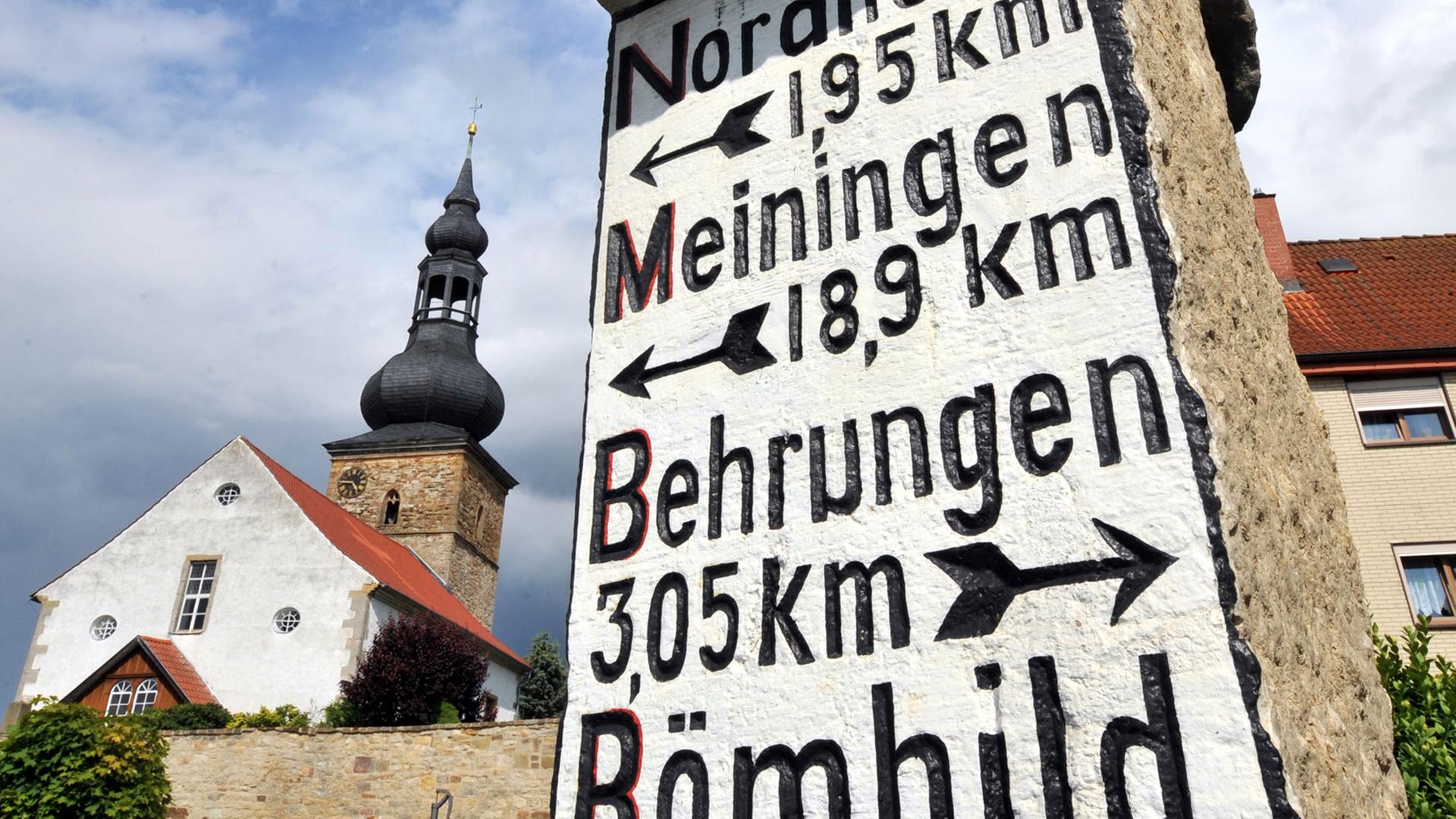 Ein historischer Wegweiser von 1912 zeigt im südthüringischen Berkach in der Rhön Richtung und Entfernung nach Nordheim, Meiningen, Behrungen und Römhild an, aufgenommen am 10.06.2009.