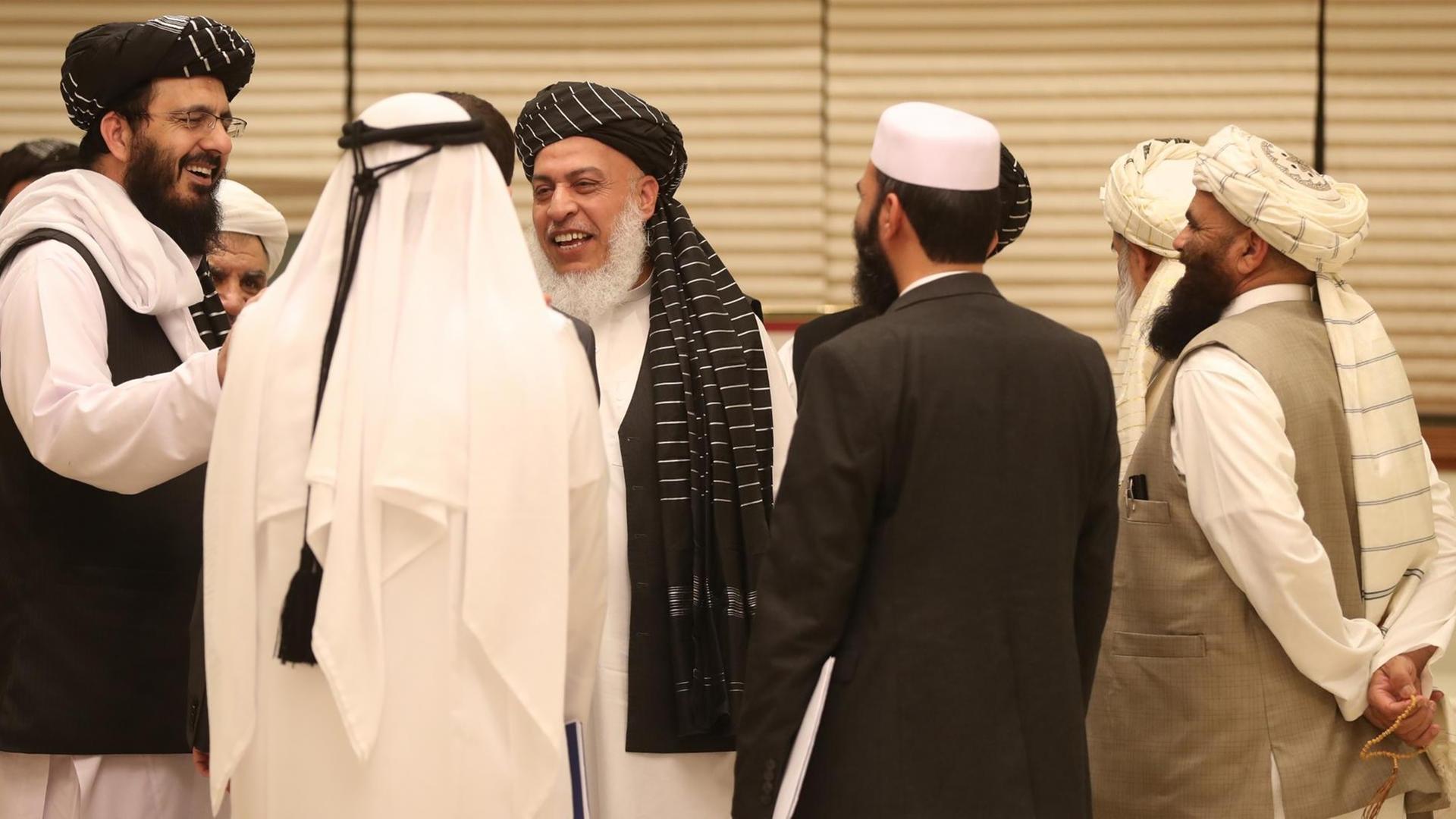 Members of Afghan delegations gather during the second day of the Intra Afghan Dialogue talks in the Qatari capital Doha on July 8, 2019. - Dozens of powerful Afghans met with a Taliban delegation on July 8, amid separate talks between the US and the insurgents seeking to end 18 years of war. The separate intra-Afghan talks are attended by around 60 delegates, including political figures, women and other Afghan stakeholders. (Photo by KARIM JAAFAR / AFP) Members of Afghan delegations gather during the second day of the Intra Afghan Dialogue talks in the Qatari capital Doha on July 8, 2019. - Dozens of powerful Afghans met with a Taliban delegation on July 8, amid separate talks between the US and the insurgents seeking to end 18 years of war. The separate intra-Afghan talks are attended by around 60 delegates, including political figures, women and other Afghan stakeholders. (Photo by KARIM JAAFAR / AFP)