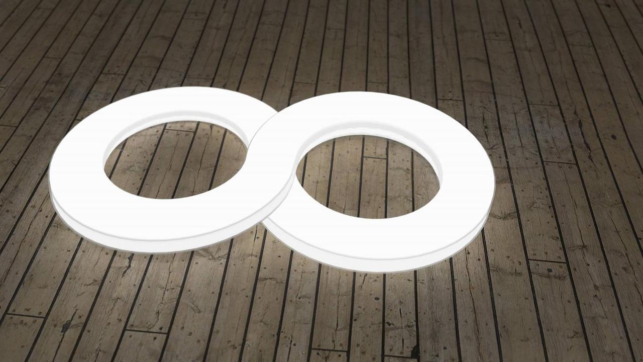Ein leuchtendes Symbol des Unendlichkeitszeichen auf dem Boden. Ein leuchtendes Symbol des Unendlichkeitszeichen auf dem Boden.