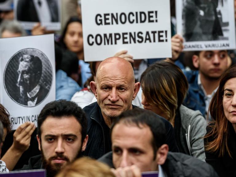 Bei Demonstrationen in Istanbul zum 101. Jahrestag des Massakers an den Armeniern halten Menschen Plakate von armenischen Intellelktuellen, die 1915 deportiert wurden.