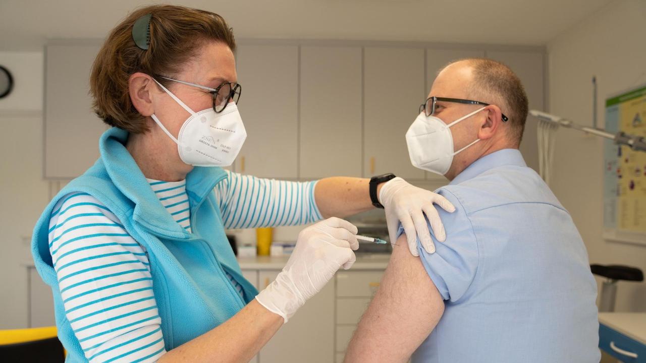 Eine Hausärztin verabreicht einem 49-jährigen Patienten die erste Impfung gegen Covid-19. 