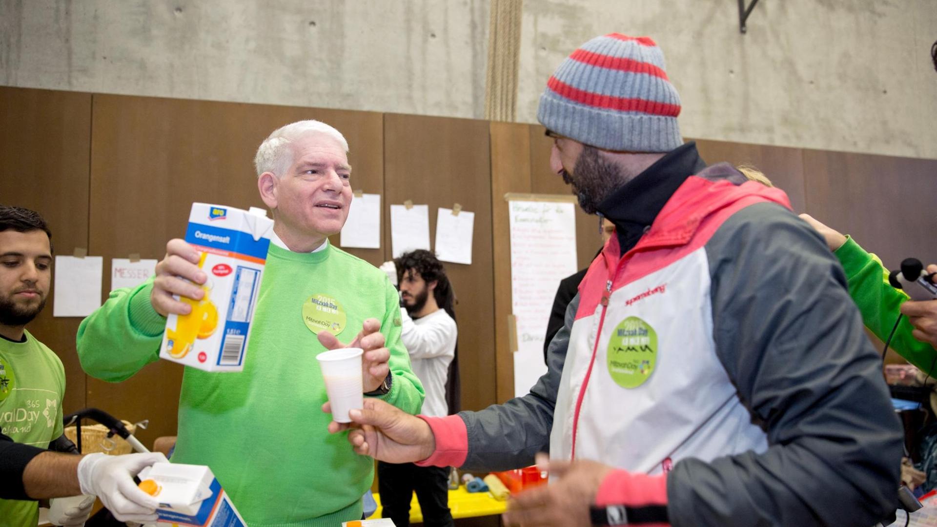 Der Präsident des Zentralrats der Juden, Schuster, verteilt im Rahmen des Mitzvah Day Essen an die Bewohner einer Flüchtlingsunterkunft in Berlin. Der Präsident des Zentralrats der Juden, Schuster, verteilt im Rahmen des Mitzvah Day Essen an die Bewohner einer Flüchtlingsunterkunft in Berlin.
