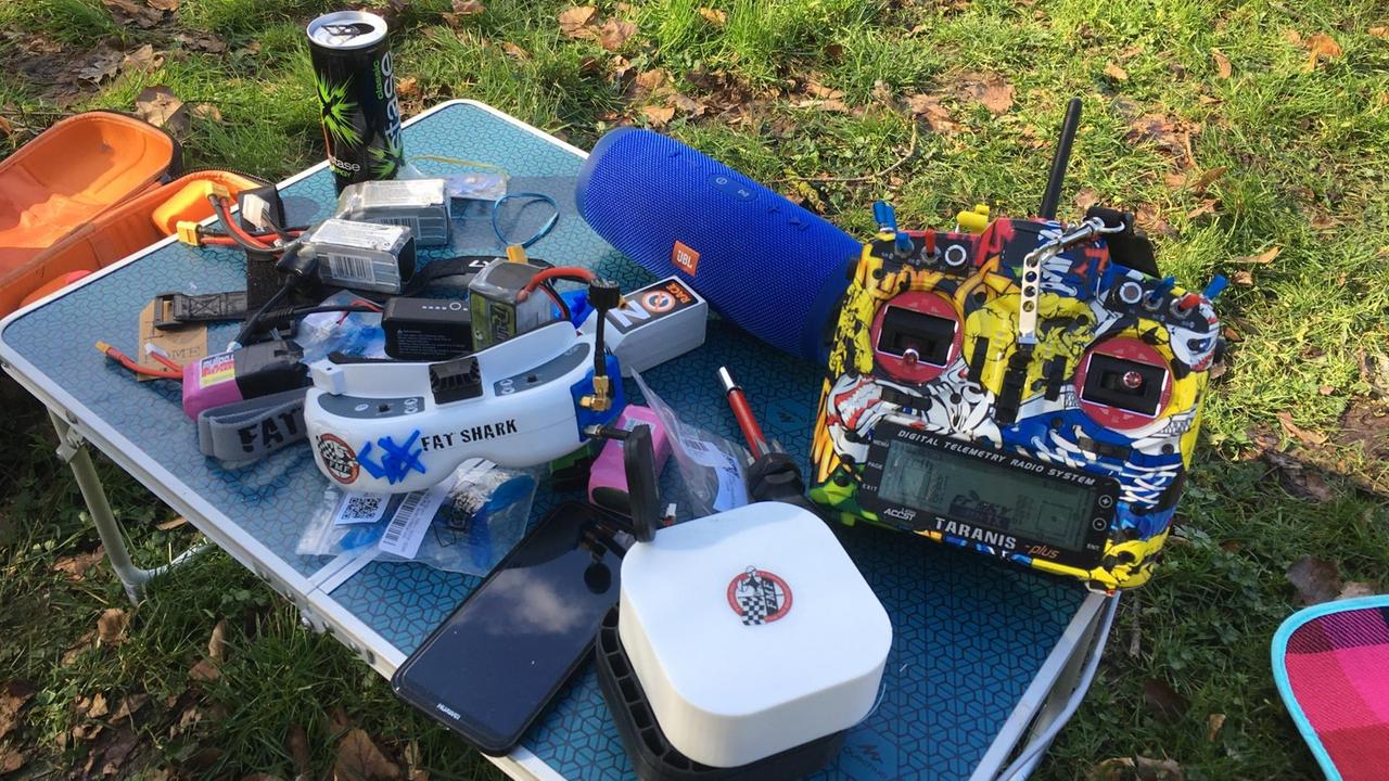 Drohnen und Zubehör auf einem kleinen Campingtisch