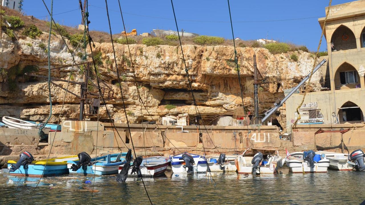 Im Fischerhafen von Beirut sind nur noch wenige kleine Boote an der Steinküste festgemacht. Oben steht ein Fischerhaus, um dort die Boote zu reparieren.