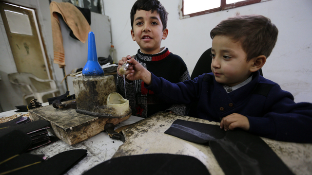 Kinder arbeiten in einem familienbetriebenen Schuhgeschäft in Hebron