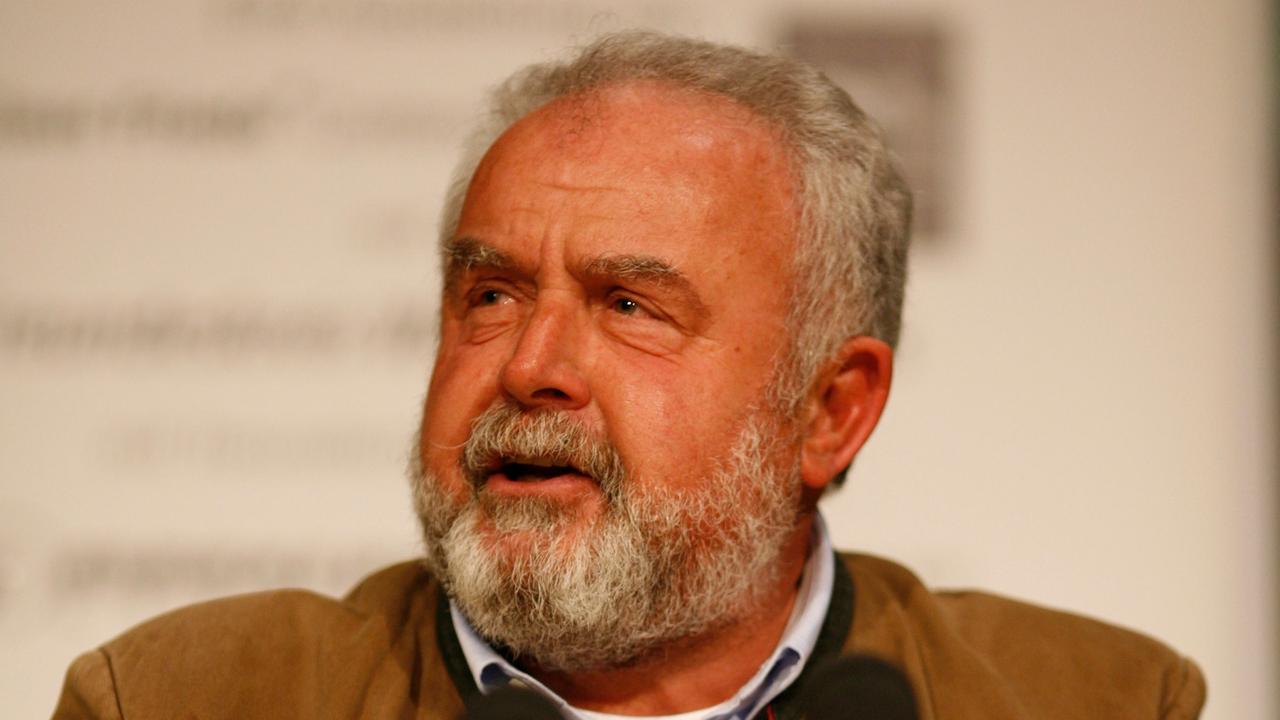 Der deutsche Arzt, Aktivist und Entwicklungshelfer Reinhard Erös an einem Rednerpult stehend und sprechend. Der deutsche Arzt, Aktivist und Entwicklungshelfer Reinhard Erös an einem Rednerpult stehend und sprechend.