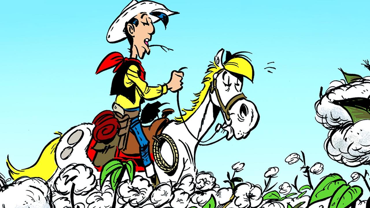 Eine Illustration aus dem Band "Fackeln im Baumwollfeld": Lucky Luke reitet über eine Baumwollplantage Eine Illustration aus dem Band "Fackeln im Baumwollfeld": Lucky Luke reitet über eine Baumwollplantage