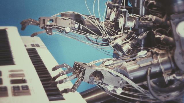 Metallene Robotter-Arme spielen auf einem weißen Piano.
