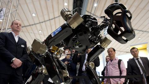 The ape-like robotic system "Charlie" walks on all of his four limbs during a demonstration at the 2014 CeBIT computer technology trade fair on March 10, 2014 in Hanover, central Germany. Developed by the German Research Center for Artificial Intelligence (DFKI) and the University of Bremen within the iStruct project (intelligent Structures for mobile robots), the robot could conceivably be used in the kind of rough terrain found on the moon. Great Britain is partner country of the fair considered as the world's biggest high-tech fair running from March 10 to 14, 2014.