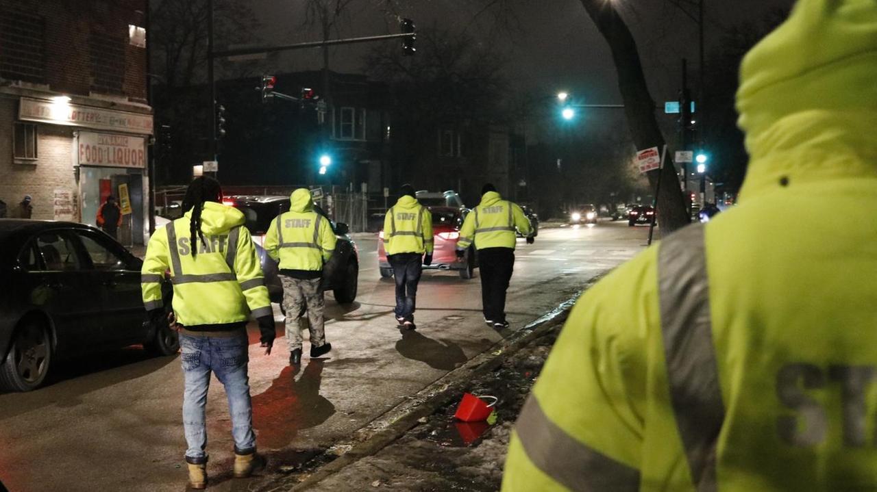 Die "Outreach-Truppe" geht durch Chicagos Süden, um Gangmitglieder zu erreichen. Sie tragen Neonfarbene Westen. Es liegt Schnee. Die "Outreach-Truppe" geht durch Chicagos Süden, um Gangmitglieder zu erreichen. Sie tragen Neonfarbene Westen. Es liegt Schnee.