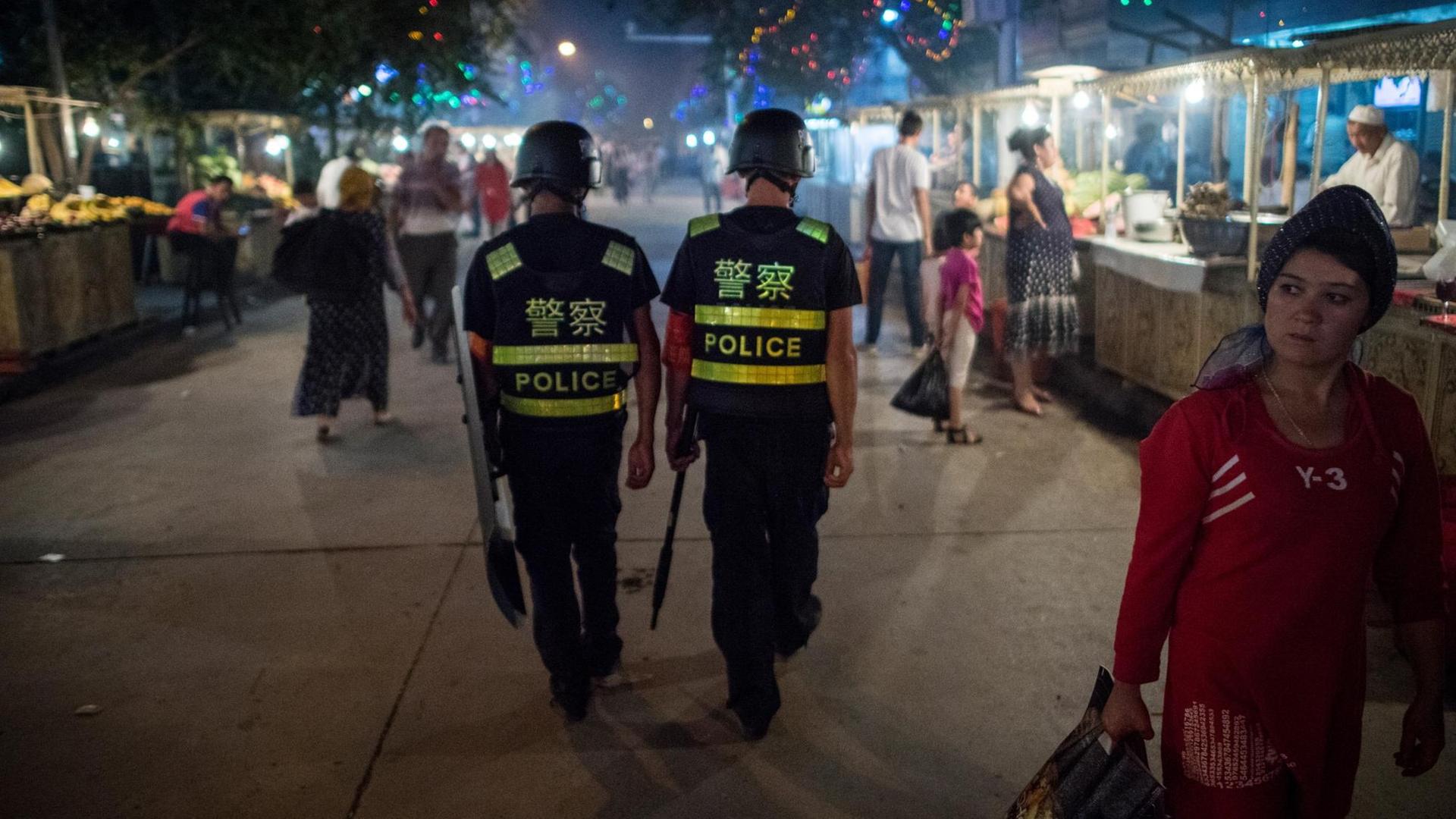 Polizisten patrouillieren am 25. Juni 2017 über einen Nachtmarkt in Kashgar in der nordwestchinesischen Region Xinjiang