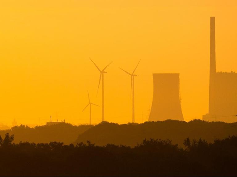 Die aufgehende Sonne taucht das Kohlekraftwerk Mehrum im Landkreis Peine am frühen Morgen in warmes Licht.