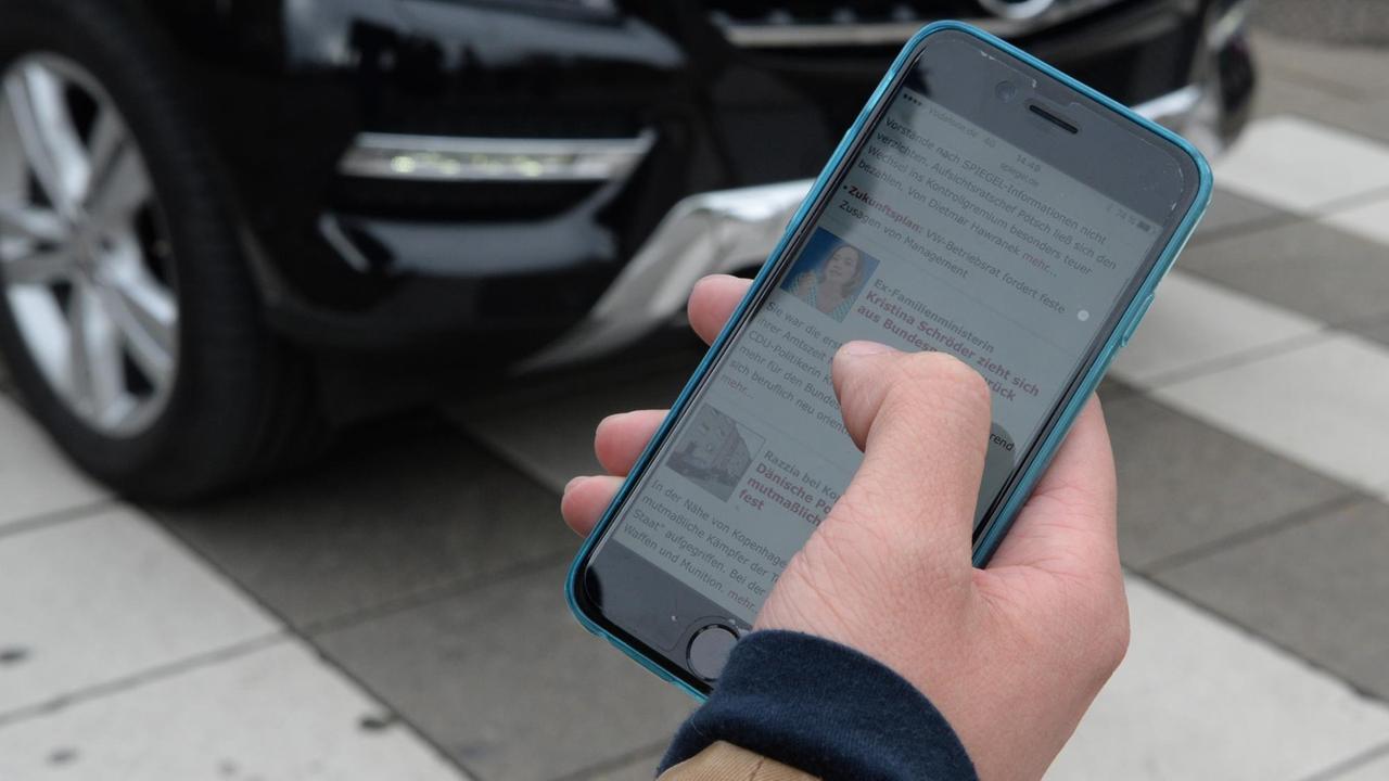 ILLUSTRATION - Eine Hand mit einem Smartphone ist am 07.04.2016 in Stuttgart (Baden-Württemberg) vor einer befahrenen Straße zu sehen. Foto: Franziska Kraufmann/dpa (zu dpa "Studie: Viele Fußgänger durch Smartphones abgelenkt" vom 08.04.2016) | Verwendung weltweit ILLUSTRATION - Eine Hand mit einem Smartphone ist am 07.04.2016 in Stuttgart (Baden-Württemberg) vor einer befahrenen Straße zu sehen. Foto: Franziska Kraufmann/dpa (zu dpa "Studie: Viele Fußgänger durch Smartphones abgelenkt" vom 08.04.2016) | Verwendung weltweit