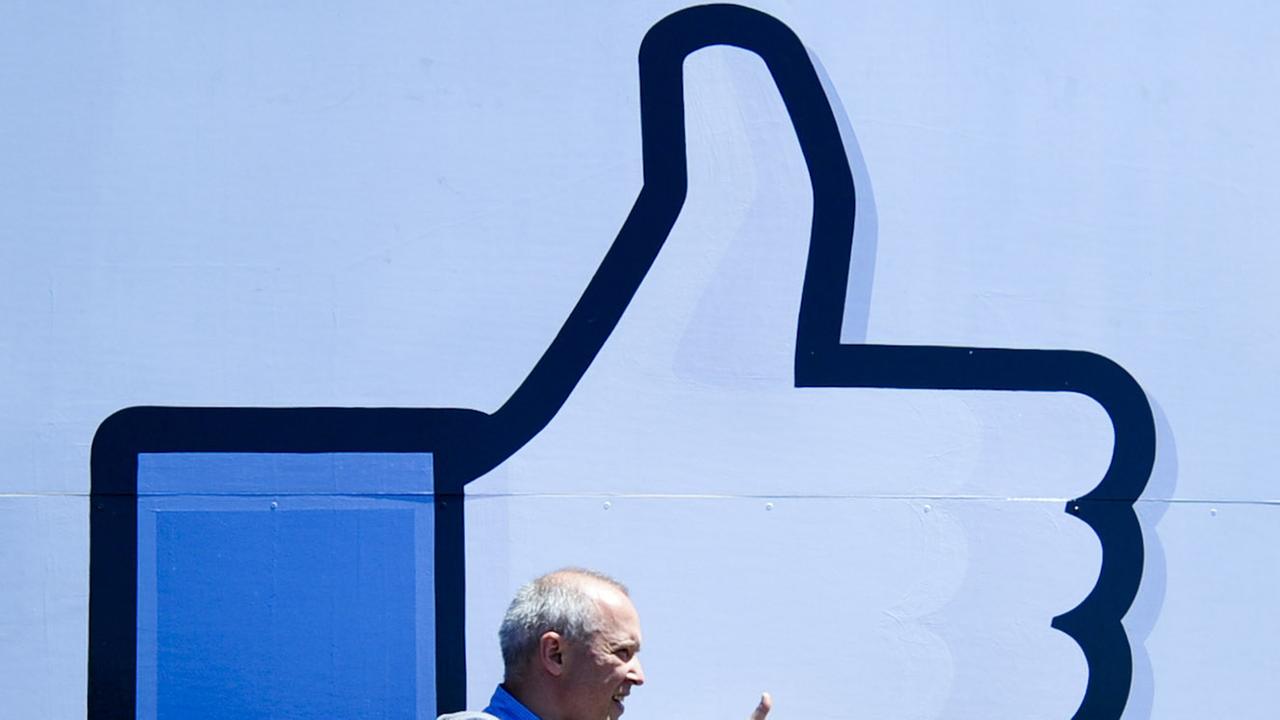 Mann vor der Gefällt-mir-Geste von Facebook Mann vor der Gefällt-mir-Geste von Facebook