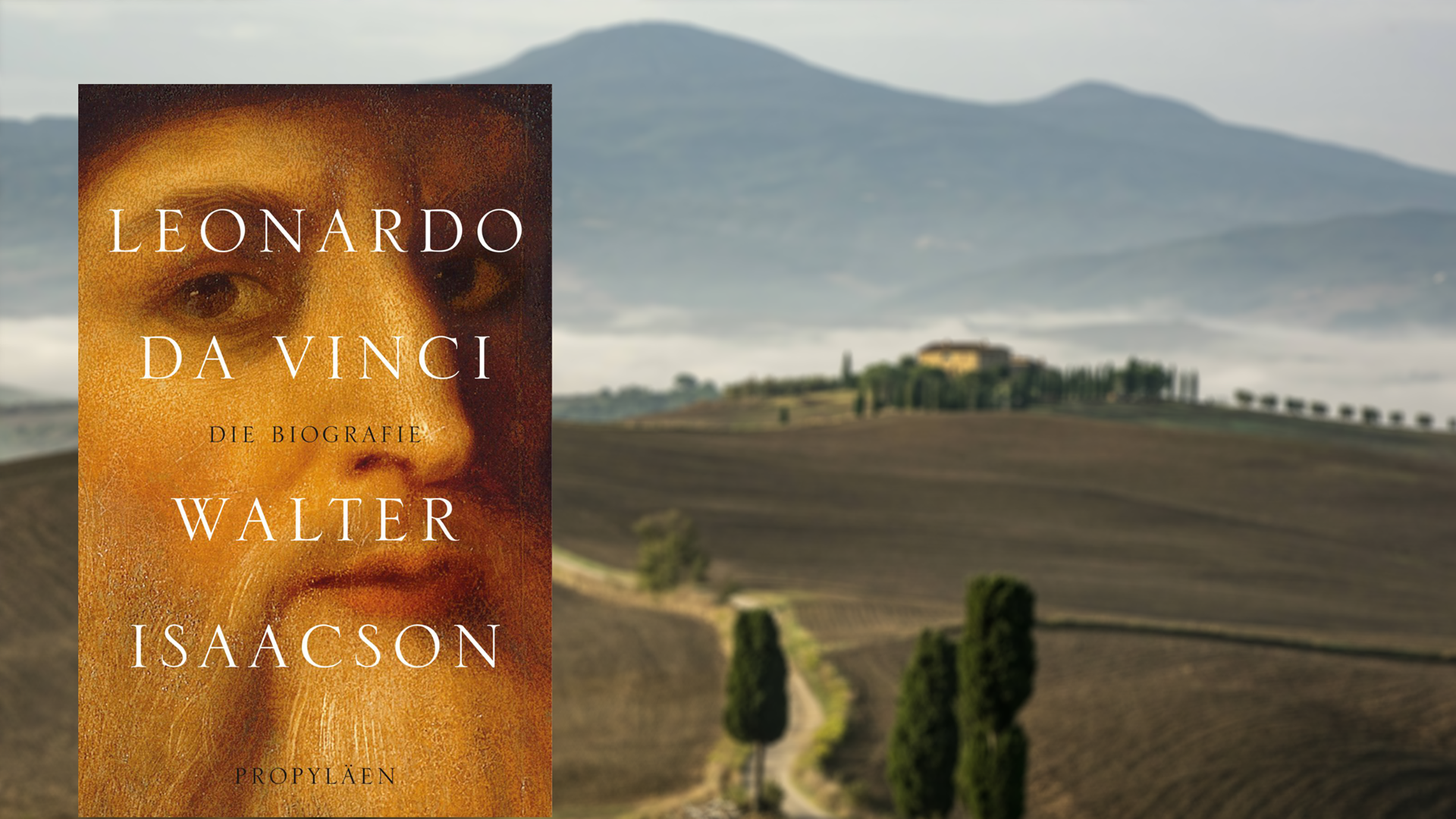 Im Vordergrund das Buchcover von Walter Isaacsons "Leonardo da Vinci", im Hintergrund unscharf eine Landschaft in der Toskana. Im Vordergrund das Buchcover von Walter Isaacsons "Leonardo da Vinci", im Hintergrund unscharf eine Landschaft in der Toskana.