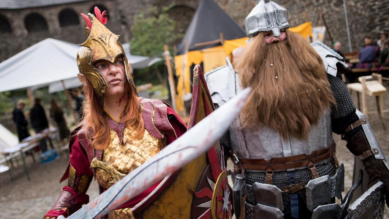 Als Elb und Zwerg aus dem Roman "Der Hobbit" verkleidete Fantasy-Fans auf der Medieval Fantasy Convention auf Schloss Burg in Solingen. Als Elb und Zwerg aus dem Roman "Der Hobbit" verkleidete Fantasy-Fans auf der Medieval Fantasy Convention auf Schloss Burg in Solingen.