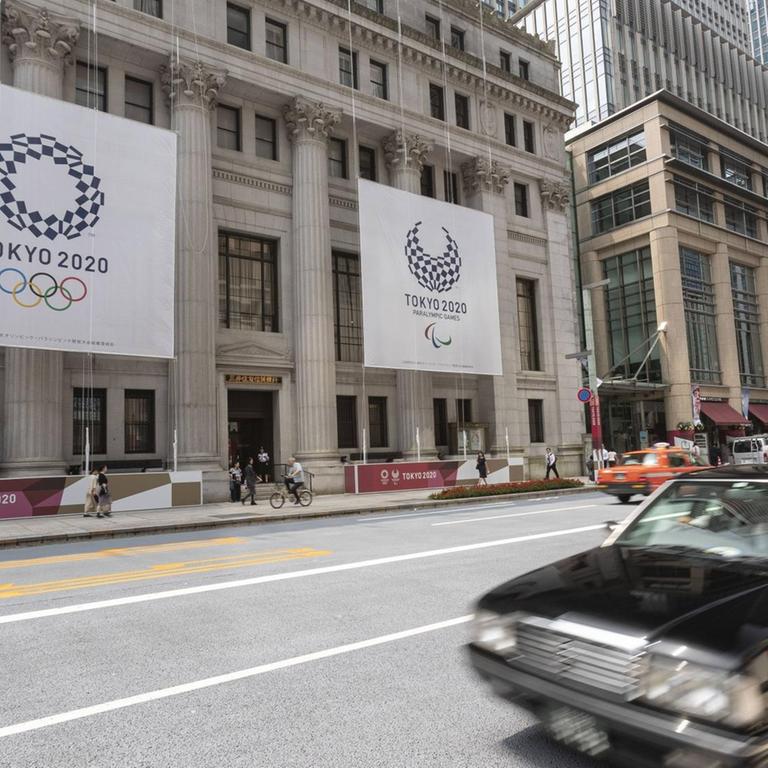 July 25, 2019, Tokyo, Japan - Huge banners of Tokyo 2020 Olympic Games are on display outside Sumitomo Mitsui Trust Bank to promote the 2020 Tokyo Olympic and Paralympic Games. Tokyo marks one year to go 2020 Olympics decorating with Olympic emblems and photos of Japanese athletes some buildings of Nihonbashi district in Tokyo. The Games are set to open on July 24, 2020. PUBLICATIONxINxGERxSUIxAUTxHUNxONLY (108582889)  