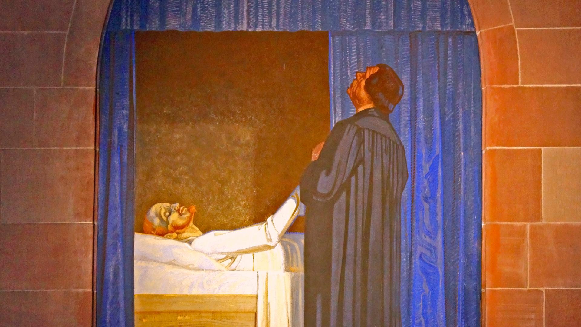 Eine Wandmalerei zeigt Martin Luther. Er besucht seinen schwer erkrankten Freund Philippus und betet um seine Wiedergenesung. Eine Wandmalerei zeigt Martin Luther. Er besucht seinen schwer erkrankten Freund Philippus und betet um seine Wiedergenesung.