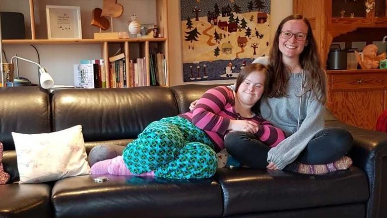 Zwei junge Frauen sitzen auf einem Sofa. Zwei junge Frauen sitzen auf einem Sofa.