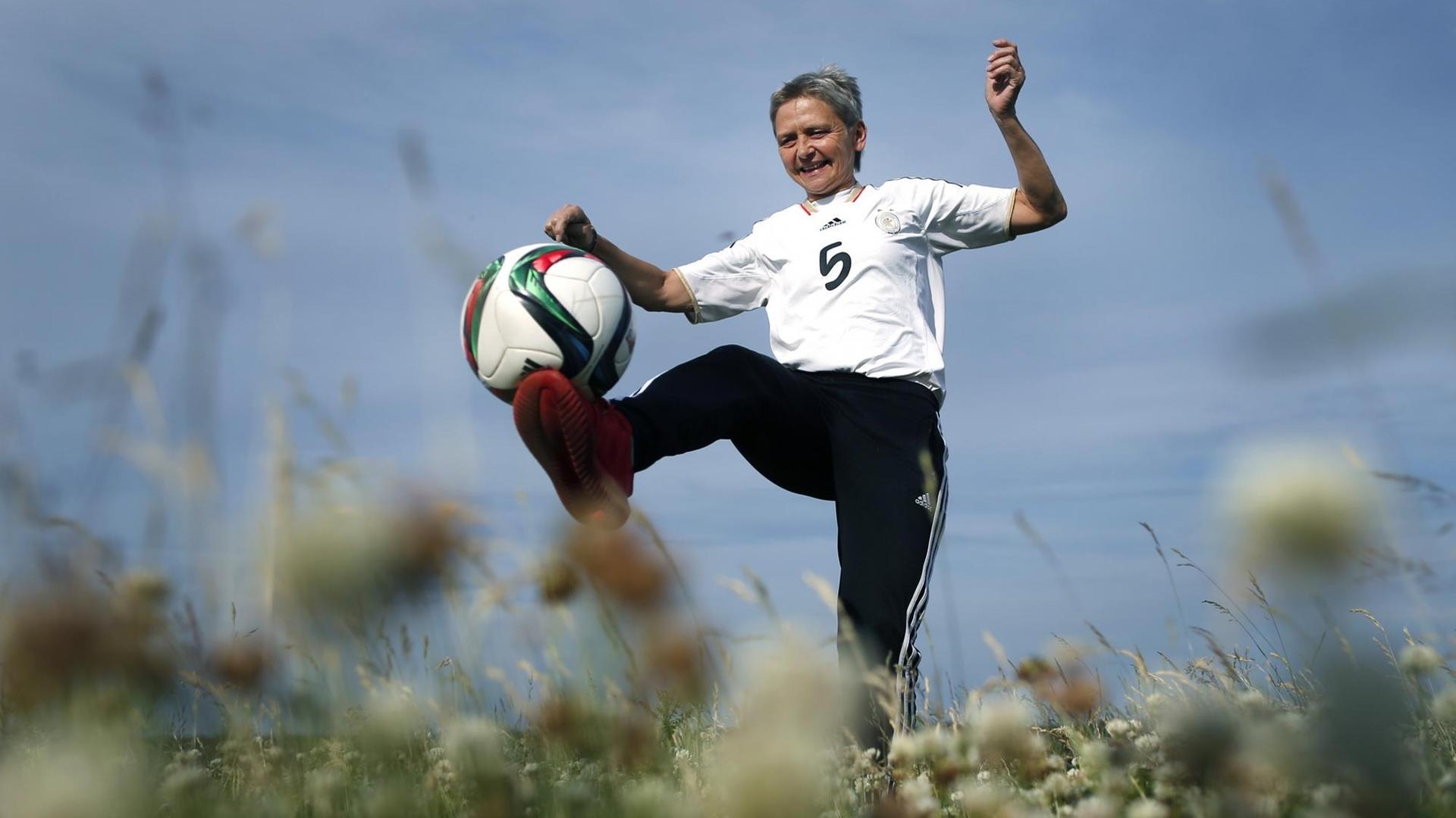 Die ehemalige Fußballnationalspielerin Petra Landers spielt mit einem Ball.