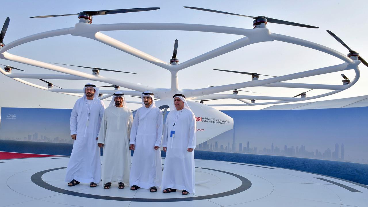 Dubais Kronprinz Sheikh Hamdan bin Mohammed Al Maktoum (2. v. r.) und drei weitere Männer stehen vor einem Volocopter Dubais Kronprinz Sheikh Hamdan bin Mohammed Al Maktoum (2. v. r.) und drei weitere Männer stehen vor einem Volocopter