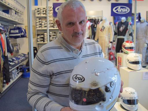 Peter Bürger mit einem Helm, der den Formel-1-Test bestanden hat. 