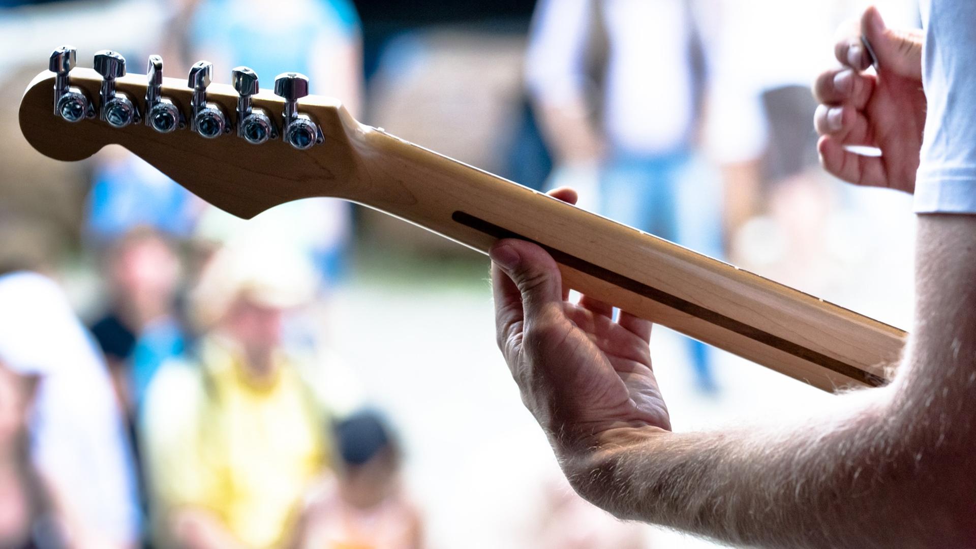 Ein Musiker spielt auf einer elektrischen Gitarre. Ein Musiker spielt auf einer elektrischen Gitarre.