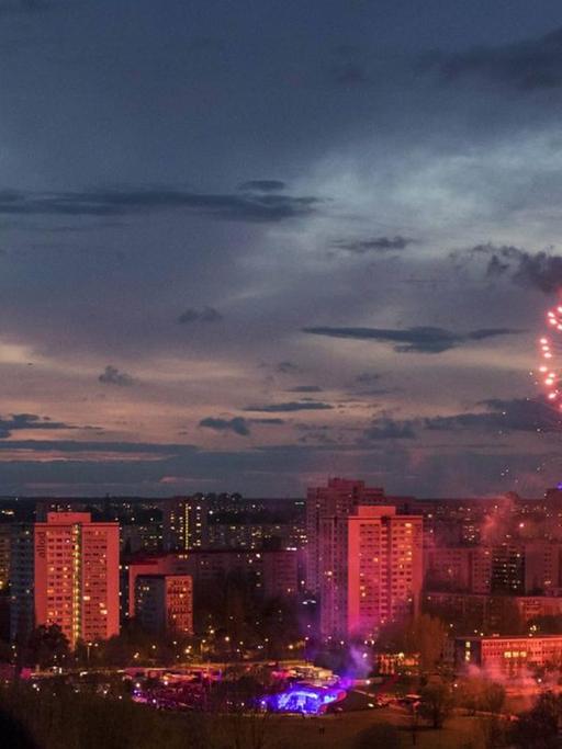 Am Eröffnungtag der Internationalen Gartenbauausstellung in den Gärten der Welt in Marzahn-Hellerdorf beobachten Besucher vor dem Hintergrund des Plattenbaugebietes ein Feuerwerk.