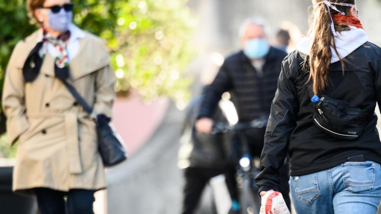 Menschen gehen durch die Fußgängerzone in Darmstadt, wo Maskenpflicht gilt Menschen gehen durch die Fußgängerzone in Darmstadt, wo Maskenpflicht gilt