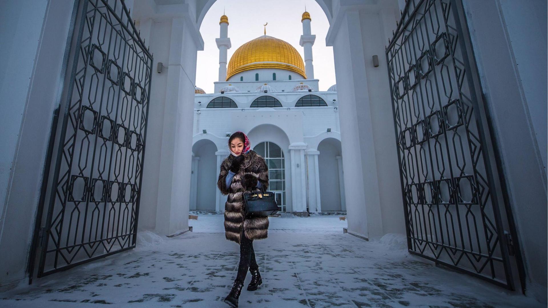 Junge Frau vor der Nur-Astana Moschee in Astana, Kasachstan.