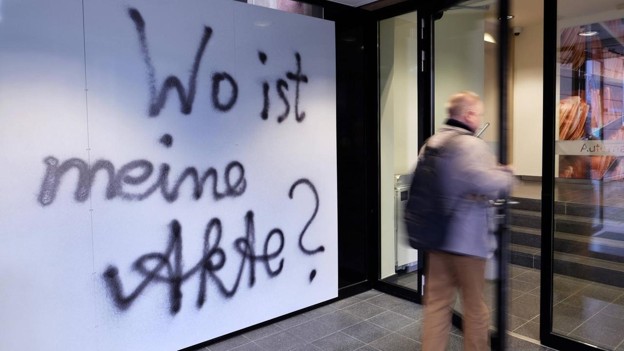 Ein Besucher beim "Tag der Archive" in der ehemaligen Zentrale des Ministeriums für Staatssicherheit (MfS) der DDR in Berlin-Lichtenberg betritt das Gebäude. An der Wand im Eingang steht ein Graffiti: "Wo ist meine Akte?", 2020. Ein Besucher beim "Tag der Archive" in der ehemaligen Zentrale des Ministeriums für Staatssicherheit (MfS) der DDR in Berlin-Lichtenberg betritt das Gebäude. An der Wand im Eingang steht ein Graffiti: "Wo ist meine Akte?", 2020.