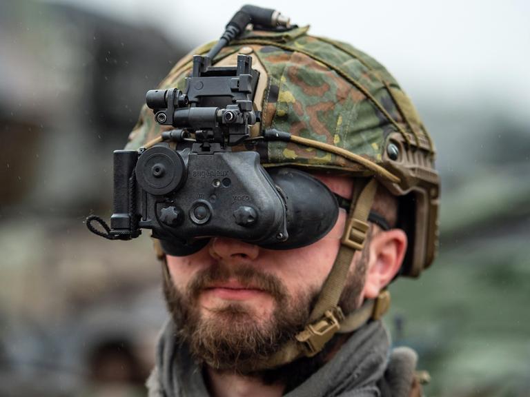 Ein Soldat der Bundeswehr ist an seinem Helm mit einem Nachtsichtgerät ausgerüstet.