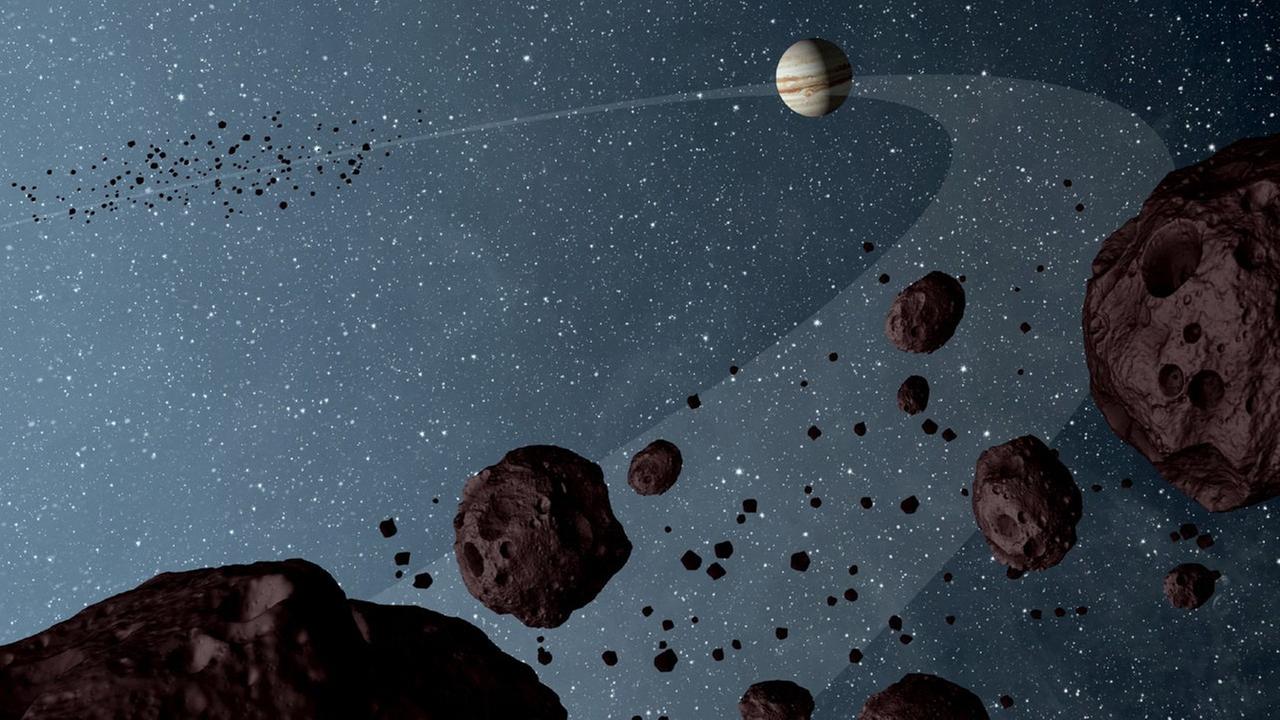 Eine NASA-Illustration zeigt die sogenannten "Trojan asteroids", die auf der Umlaufbahn des Jupiters in derselben Richtung kreisen. Ein kleiner Asteroid kreuzt als "kosmischer Geisterfahrer" seit mindestens einer Million Jahren die Bahn des Riesenplaneten. Eine NASA-Illustration zeigt die sogenannten "Trojan asteroids", die auf der Umlaufbahn des Jupiters in derselben Richtung kreisen. Ein kleiner Asteroid kreuzt als "kosmischer Geisterfahrer" seit mindestens einer Million Jahren die Bahn des Riesenplaneten.