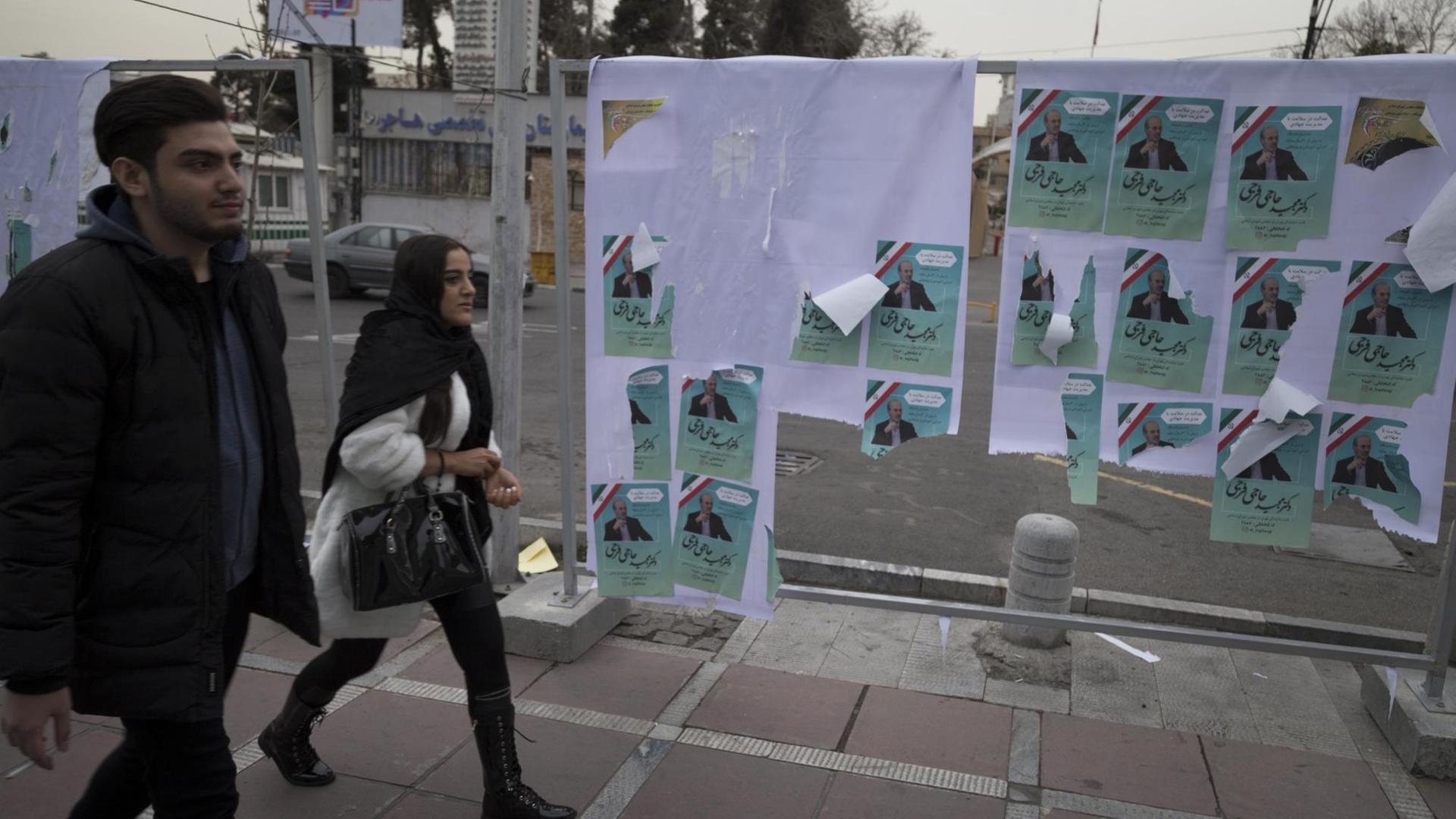 February 19, 2020, Tehran, Iran: Iranians walk past electoral posters during the last day of the election campaign, Tehran, Iran. Iranians will go to the polls to vote in the parliamentary elections on 21 February 2020. Some 7,000 candidates are running in 208 constituencies for the 290-seat chamber. They kicked off their campaigns last Thursday, even after authorities barred thousands of others from running, mainly reformists and moderates. (Credit Image: © Rouzbeh Fouladi/ZUMA Wire | February 19, 2020, Tehran, Iran: Iranians walk past electoral posters during the last day of the election campaign, Tehran, Iran. Iranians will go to the polls to vote in the parliamentary elections on 21 February 2020. Some 7,000 candidates are running in 208 constituencies for the 290-seat chamber. They kicked off their campaigns last Thursday, even after authorities barred thousands of others from running, mainly reformists and moderates. (Credit Image: © Rouzbeh Fouladi/ZUMA Wire |