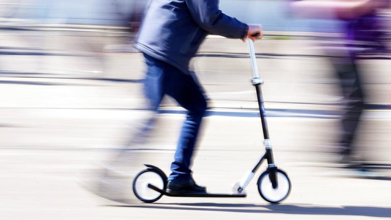 Ein Mann fährt mit einem Roller über das Tempelhofer Feld in Berlin.