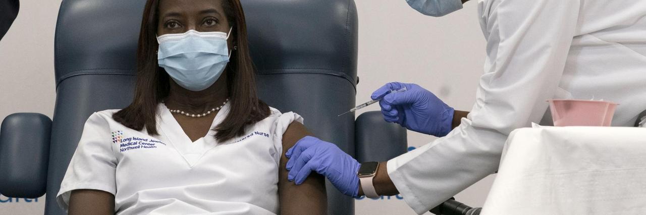 Sandra Lindsay, left, a nurse at Long Island Jewish Medical Center, is inoculated with the Pfizer-BioNTech COVID-19 vaccine by Dr. Michelle Chester, Monday, Dec. 14, 2020, in the Queens borough of New York. (AP Photo/Mark Lennihan, Pool) Sandra Lindsay, left, a nurse at Long Island Jewish Medical Center, is inoculated with the Pfizer-BioNTech COVID-19 vaccine by Dr. Michelle Chester, Monday, Dec. 14, 2020, in the Queens borough of New York. (AP Photo/Mark Lennihan, Pool)