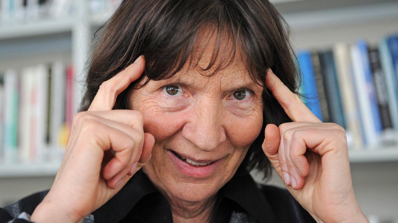 Die Kulturwissenschaftlerin Aleida Assmann, vor einem Bücherregal, hält sich ihre Zeigefingern an die Schläfe. Die Kulturwissenschaftlerin Aleida Assmann, vor einem Bücherregal, hält sich ihre Zeigefingern an die Schläfe.