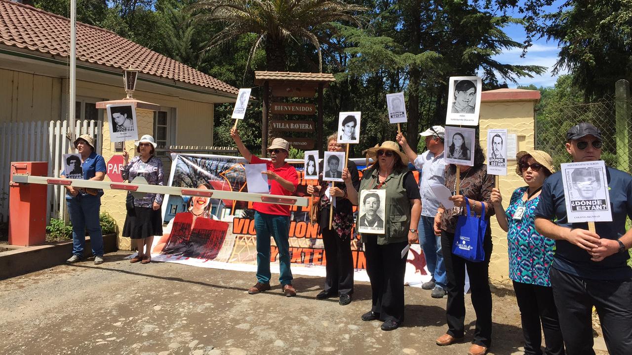 Demonstration von Angehörigen von Opfern der chilenischen Militärdiktatur vor dem verschlossenen Eingang zur Villa Baviera