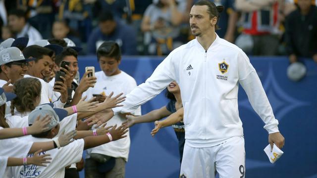 Zlatan Ibrahimovic wird von einer Gruppe junger Fans belagert.