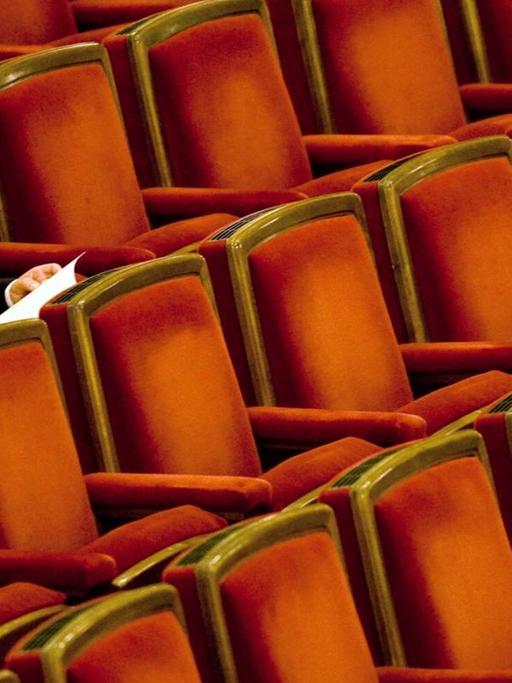 Ein Mann sitzt im Zuschauersaal der Semperoper in Dresden und wartet auf das Antrittskonzert von Christian Thielemann.