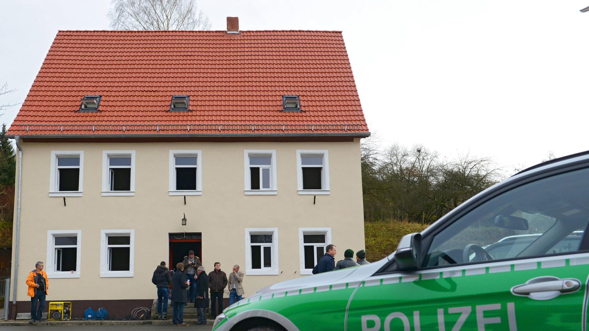 Ein Polizeiauto steht vor einem Haus im bayrischen Vorra, auf das Unbekannte einen Anschlag verübt haben.
