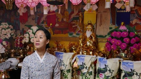 Schamanin Min Hae-Kyung neben einer Figur eines Berggeistes Schamanin Min Hae-Kyung neben einer Figur eines Berggeistes