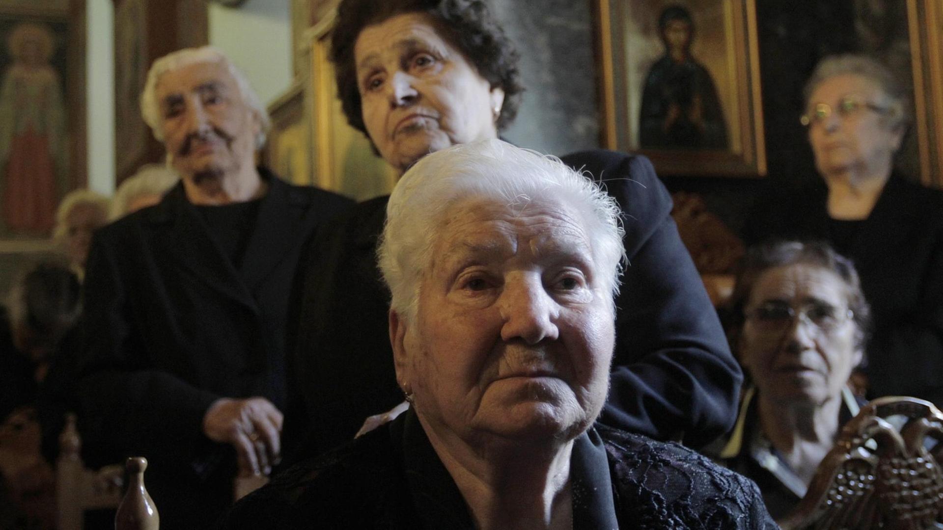 epa04800298 (05/18) Women, survivors of the Distomo massacre, attend a memorial service for the victims of the Distomo massacre during World War II, in Distomo, Greece, 10 June 2015. In Distomo, Nazi troops slaughtered 218 men, women and children in reprisal for acts of resistance on 10 June 1944. During WWII, Greece lost 10 percent of its population, almost one million people, of which 400,000 starved to death, according to statistics. Greece has never waived its claim for war reparations from Germany, while survivors of Nazi atrocities in Greek towns and villages are currently in court battles to claim compensation. EPA/ORESTIS PANAGIOTOU PLEASE REFER TO THIS ADVISORY NOTICE (epa04800291) FOR FULL PACKAGE TEXT | epa04800298 (05/18) Women, survivors of the Distomo massacre, attend a memorial service for the victims of the Distomo massacre during World War II, in Distomo, Greece, 10 June 2015. In Distomo, Nazi troops slaughtered 218 men, women and children in reprisal for acts of resistance on 10 June 1944. During WWII, Greece lost 10 percent of its population, almost one million people, of which 400,000 starved to death, according to statistics. Greece has never waived its claim for war reparations from Germany, while survivors of Nazi atrocities in Greek towns and villages are currently in court battles to claim compensation. EPA/ORESTIS PANAGIOTOU PLEASE REFER TO THIS ADVISORY NOTICE (epa04800291) FOR FULL PACKAGE TEXT |