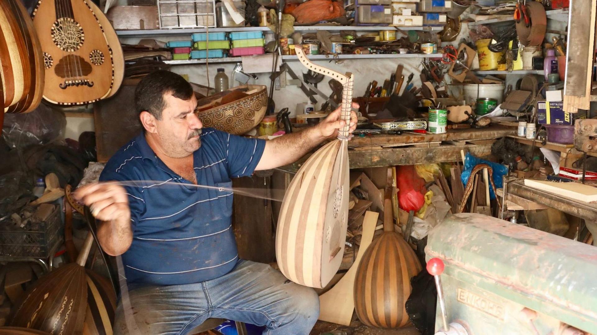 (180915) -- BAGHDAD, Sept. 15, 2018 -- Ali al-Abdali, an owner of a lute manufacturing workshop, makes lute in Rasheed Street in downtown Baghdad, Iraq on Aug. 26, 2018. TO GO WITH Feature: Lute manufacturing in Baghdad resists extinction )(axy) IRAQ-BAGHDAD-LUTE MAKING KhalilxDawood PUBLICATIONxNOTxINxCHN (180915) -- BAGHDAD, Sept. 15, 2018 -- Ali al-Abdali, an owner of a lute manufacturing workshop, makes lute in Rasheed Street in downtown Baghdad, Iraq on Aug. 26, 2018. TO GO WITH Feature: Lute manufacturing in Baghdad resists extinction )(axy) IRAQ-BAGHDAD-LUTE MAKING KhalilxDawood PUBLICATIONxNOTxINxCHN