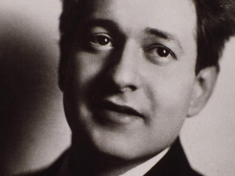 Komponist Erich Wolfgang Korngold lächelt in einer schwarz-weißen Porträtaufnahme.