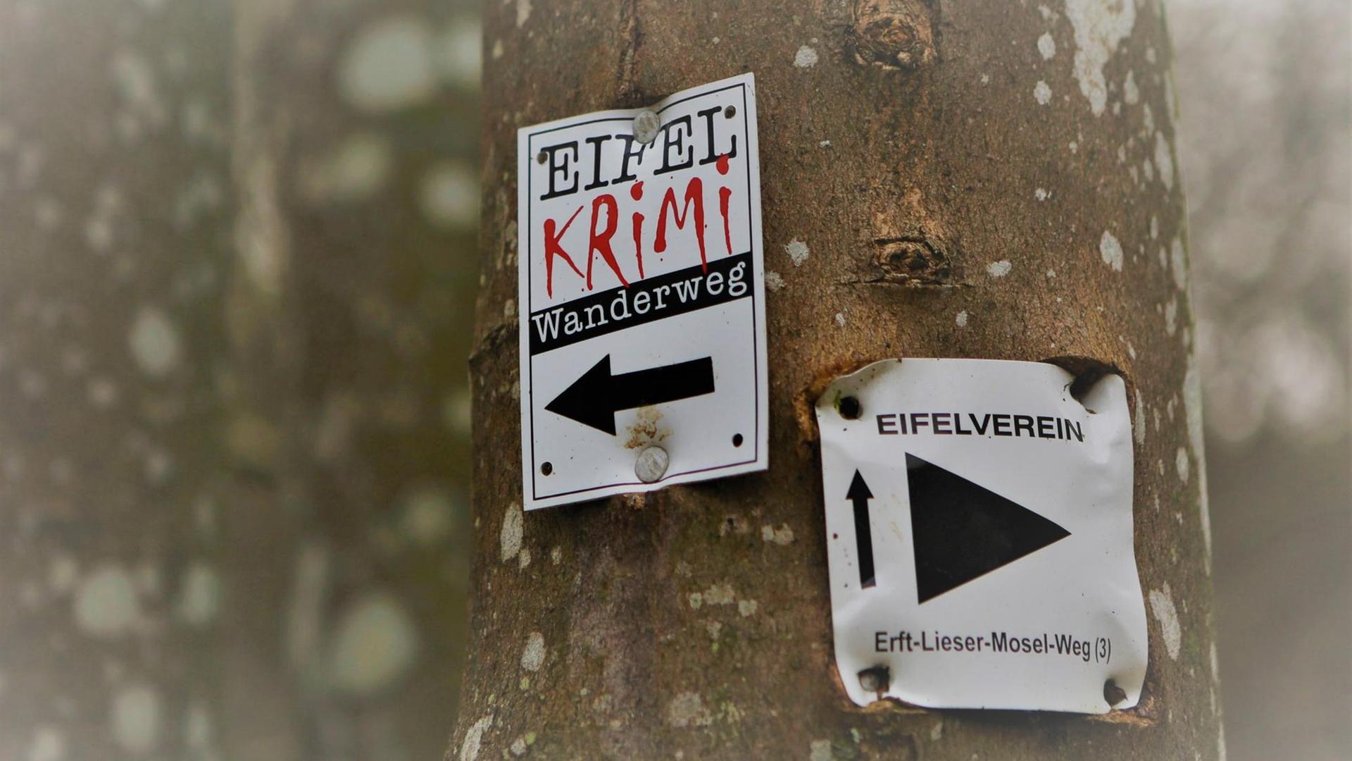 Hinweis an einem Baum Eifelkrimi Wanderweg und Eifelverein Erft Liesser Mosel Weg. Der Eifelkrimi-Wanderweg verbindet 11 Schauplätze miteinander, wobei er in zwei Routen von 18 und 20 km Länge aufgeteilt ist. Wanderung bei Kerpen ( Vulkaneifel ) Hinweis an einem Baum Eifelkrimi Wanderweg und Eifelverein Erft Liesser Mosel Weg. Der Eifelkrimi-Wanderweg verbindet 11 Schauplätze miteinander, wobei er in zwei Routen von 18 und 20 km Länge aufgeteilt ist. Wanderung bei Kerpen ( Vulkaneifel )