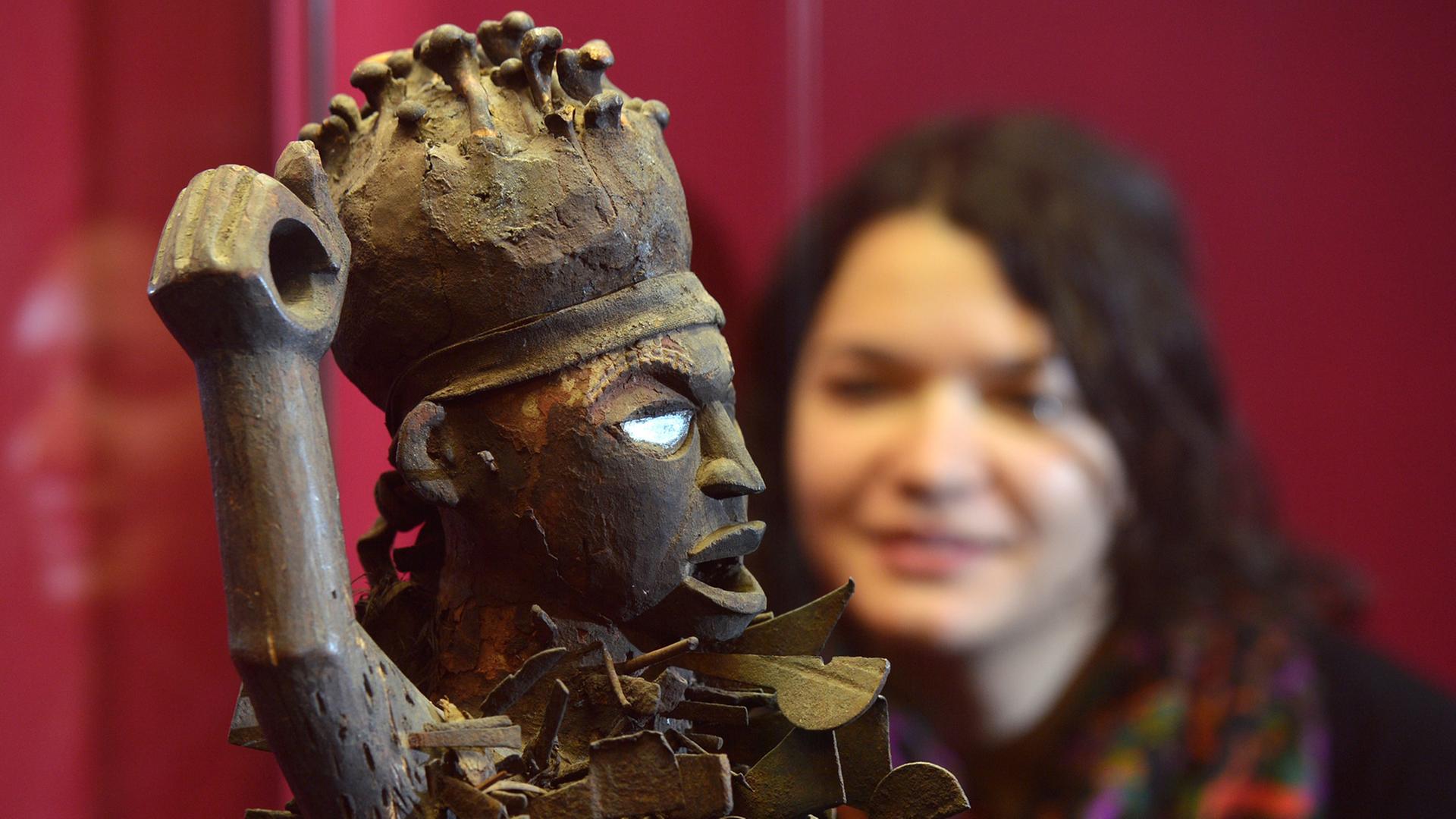 Eine Besucherin des Grassi Museums für Völkerkunde in Leipzig betrachtet am eine sogenannte Minkisi-Skulptur aus der umfangreichen Sammlung afrikanischer Schnitzfiguren mit geheimnisvollen Kräften